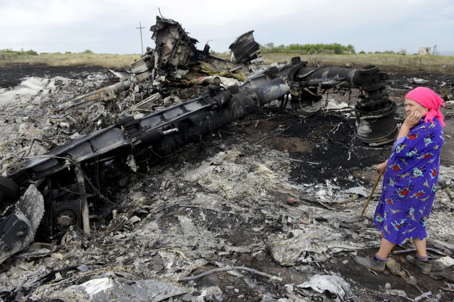 A woman looks at wreckage on July 19, 2014.