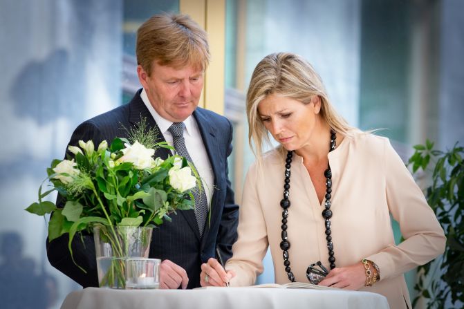 King Willem-Alexander and Queen Maxima of the Netherlands sign a condolence register for relatives and friends of the victims of Malaysia Airlines Flight 17 at the Ministry of Safety and Justice in The Hague on Friday, July 18. 