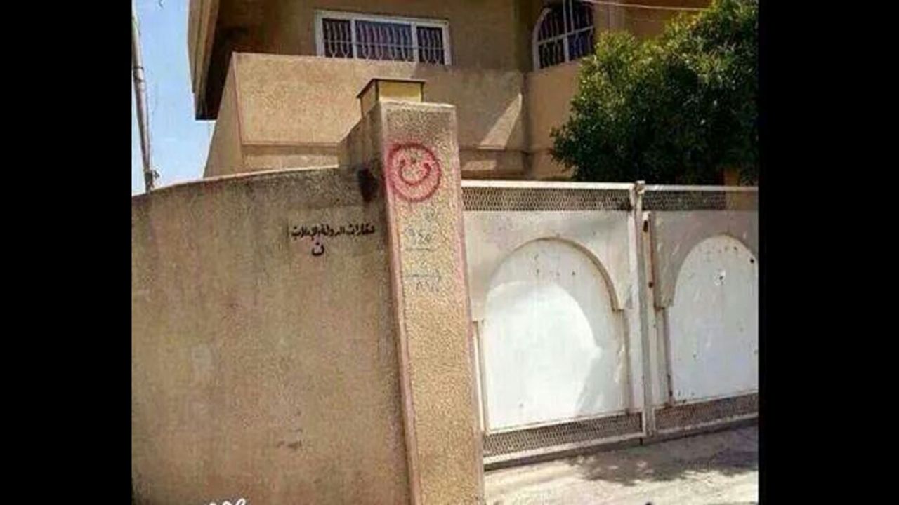 A house in Mosul, Iraq, has the words "property of ISIS" painted on a wall. 