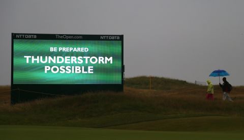 Bad weather threatened to disrupt the third round, but the predicted thunderstorms skirted the course located on England's northwest coast. As a precaution, tournament officials started play early on Saturday with players teeing off from both the first and 10th holes -- a first in Open Championship history.   