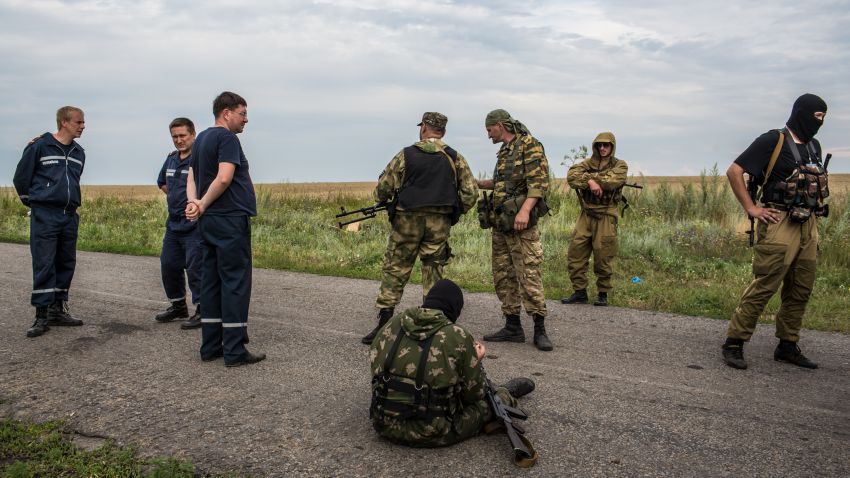 Pro-Russia separatist fighters and emergency personnel gather near the scene of the crash of Malaysia Airlines flight MH 17 on July 19, 2014 in Grabovo, Ukraine. Malaysia Airlines flight MH17 was travelling from Amsterdam to Kuala Lumpur when it crashed killing all 298 on board including 80 children. The aircraft was allegedly shot down by a missile and investigations continue over the perpetrators of the attack. (Photo by Brendan Hoffman/Getty Images