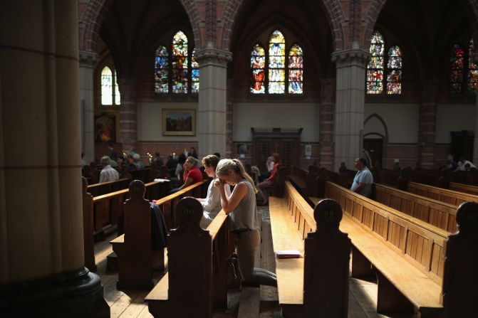 People pray during a special Mass in memory of the victims of Malaysia Airlines Flight 17 on July 20 in St. Vitus Church in Hilversum, Netherlands. The United States says a surface-to-air missile took down the Boeing 777 in eastern Ukraine on July 17 as it was flying from Amsterdam, Netherlands, to Kuala Lumpur, Malaysia, killing all 298 people aboard. At least 192 of the dead were Dutch.