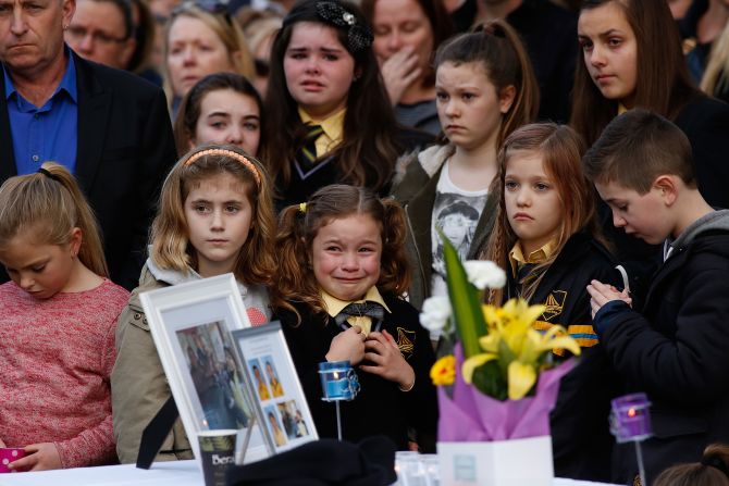 Mourners in Eynesbury, Australia, attend a memorial service Sunday, July 20, for a family of five killed in the disaster.