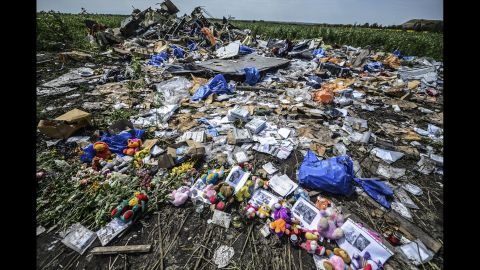 Flowers, soft toys along with pictures are left amongst the wreckage at the site of the crash of  on July 20, 2014. 