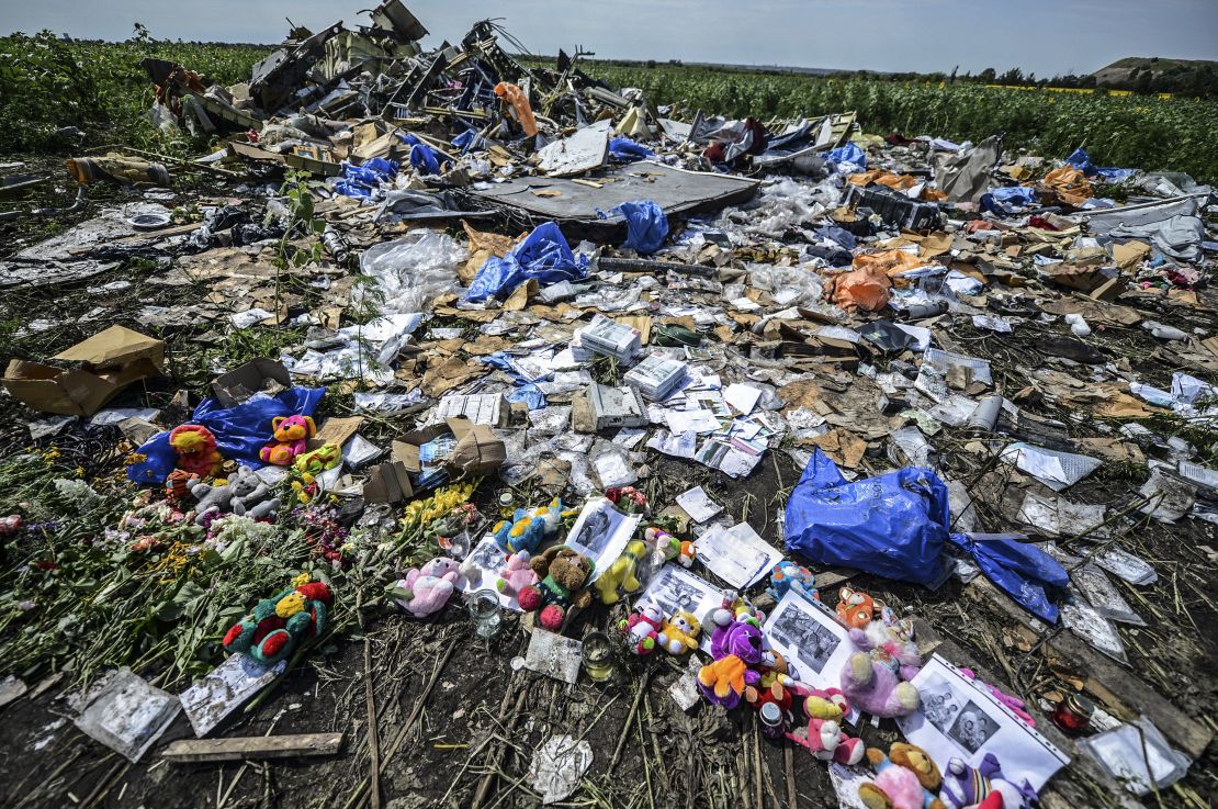 Flowers, soft toys along with pictures are left among the wreckage at the site of the crash of a Malaysia Airlines plane carrying 298 people from Amsterdam to Kuala Lumpur.
