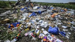 Flowers, soft toys along with pictures are left amongst the wreckage at the site of the crash of a Malaysia Airlines plane carrying 298 people from Amsterdam to Kuala Lumpur, in Grabove, in the region of Donetsk on July 20, 2014.
