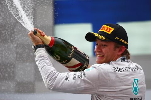 Nico Rosberg enjoys a champagne moment after wrapping up victory in the German Grand Prix at Hockenheim.