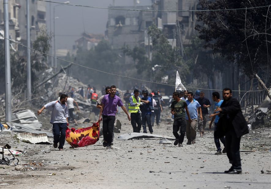 Palestinian medics carry a body in Gaza's Shaja'ia district on July 20.