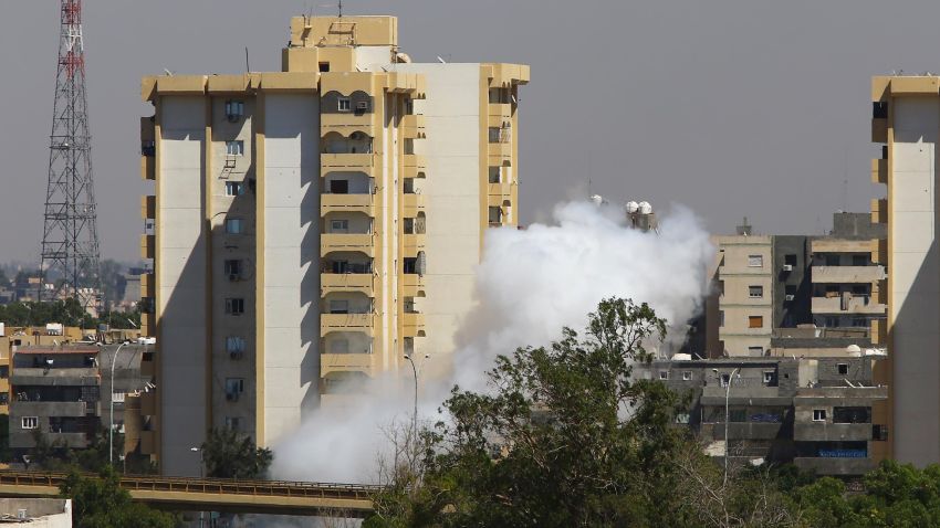 Smoke billows near a road leading to Tripoli international airport during clashes between Islamist-led militiamen and rival ex-rebels who control the facility, on July 20, 2014, in the Libyan capital Tripoli.