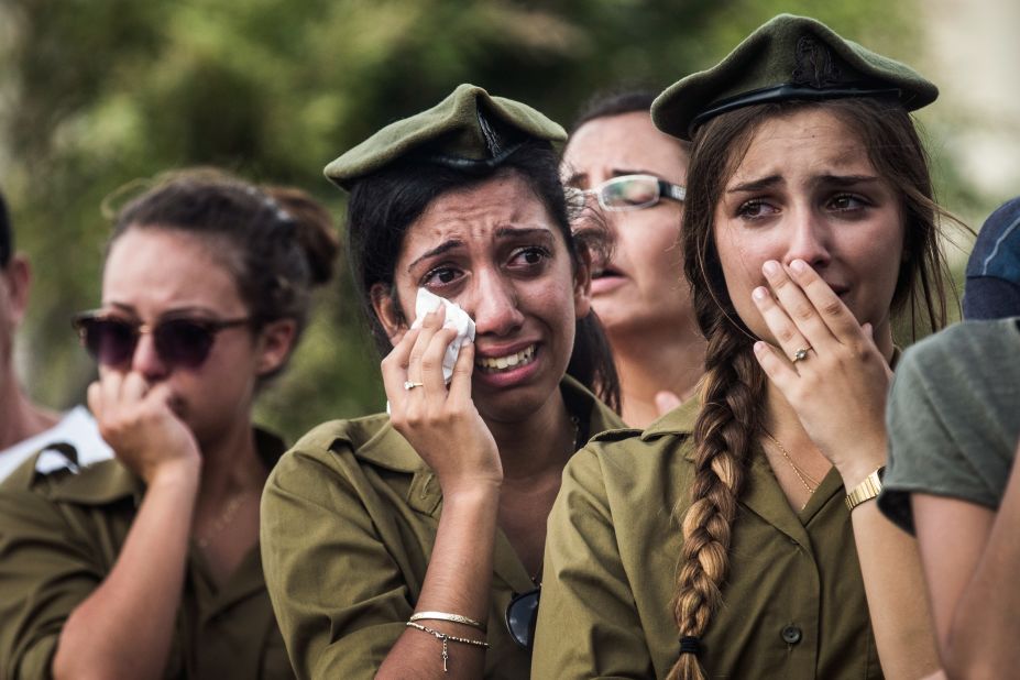 Israeli soldiers weep at the grave of Israeli Sgt. Adar Barsano during his funeral Sunday, July 20, in Nahariya, Israel.