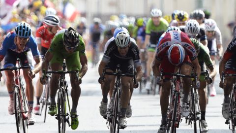Alexander Kristoff of the Katusha team wins the 15th stage of the Tour de France with Jack Bauer (far left) overhauled in the final meters.