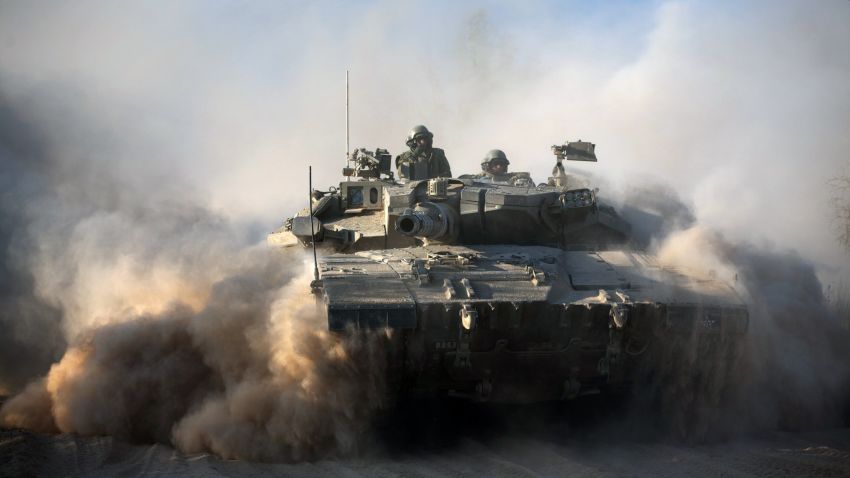 An Israeli soldier is seen on a Merkava tank, as part of the Israeli army deployment near Israel's border with the Gaza Strip on July 20, 2014. The number of Palestinians killed in Israeli attacks in the Gaza Strip on July 20 was at least 100. It was the bloodiest single day in the battered enclave in five years, taking the Palestinian toll on the 13th day of Israel's Gaza offensive to 438. AFP PHOTO / MENAHEM KAHANA (Photo credit should read MENAHEM KAHANA/AFP/Getty Images)