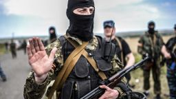 An armed pro-Russian separatists gestures as he blocks the way to the crash site of Malaysia Airlines Flight MH17, near the village of Grabove, in the region of Donetsk on July 20, 2014.