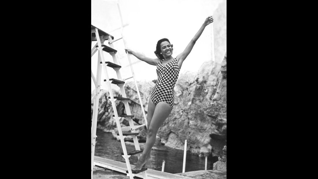 Actress Dorothy Dandridge showcases her trademark Hollywood glamor while frolicking in a checkered one-piece in 1957.