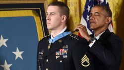 US President Barack Obama awards Ryan M. Pitts, a former active duty Army Staff Sergeant, the Medal of Honor for conspicuous gallantry in the East Room at the White House in Washington, DC, on July 21, 2014. Staff Sergeant Pitts received the Medal of Honor for his courageous actions while serving as a Forward Observer with 2nd Platoon, Chosen Company, 2nd Battalion (Airborne), 503rd Infantry Regiment, 173rd Airborne Brigade, during combat operations at Vehicle Patrol Base Kahler, in the vicinity of Wanat Village in Kunar Province, Afghanistan on July 13, 2008. AFP PHOTO/Jewel Samad        (Photo credit should read JEWEL SAMAD/AFP/Getty Images)