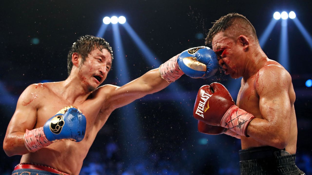 Zou Shiming punches Luis De La Rosa during their WBO International flyweight title bout Saturday, July 19, in Macau, China. Zou won by unanimous decision.