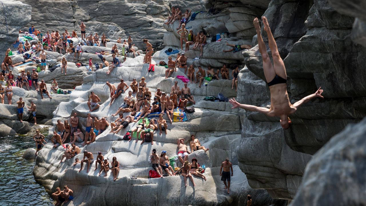 Liam Atkins dives from 20 meters (65.6 feet) as spectators in Ponte Brolla, Switzerland, watch him compete in the International Cliff Diving Championship on Saturday, July 19. The Australian finished fourth in the men's competition, which was won by Russia's Ilya Shchurov.