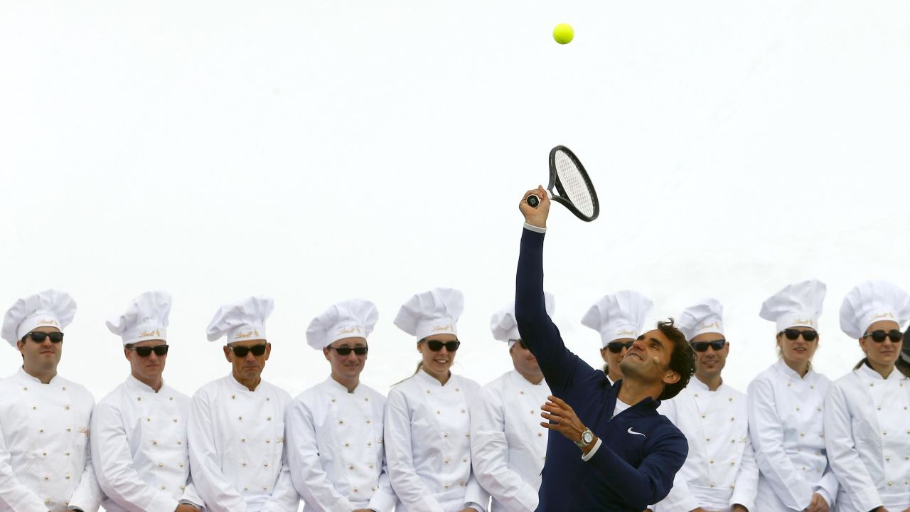 Swiss tennis player Roger Federer serves a ball to U.S. skier Lindsey Vonn during a promotional event on Switzerland's Aletsch Glacier on Wednesday, July 16. The two superstar athletes played tennis on a specially prepared court atop the glacier, more than 11,000 feet above sea level.