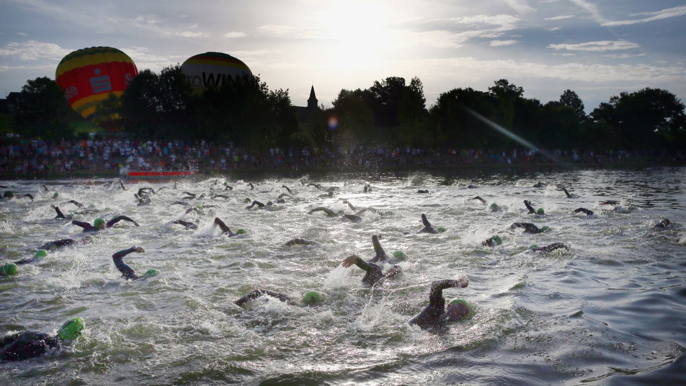 Participants compete in the swimming portion of the Challenge Roth triathlon Sunday, July 20, in Roth, Germany.