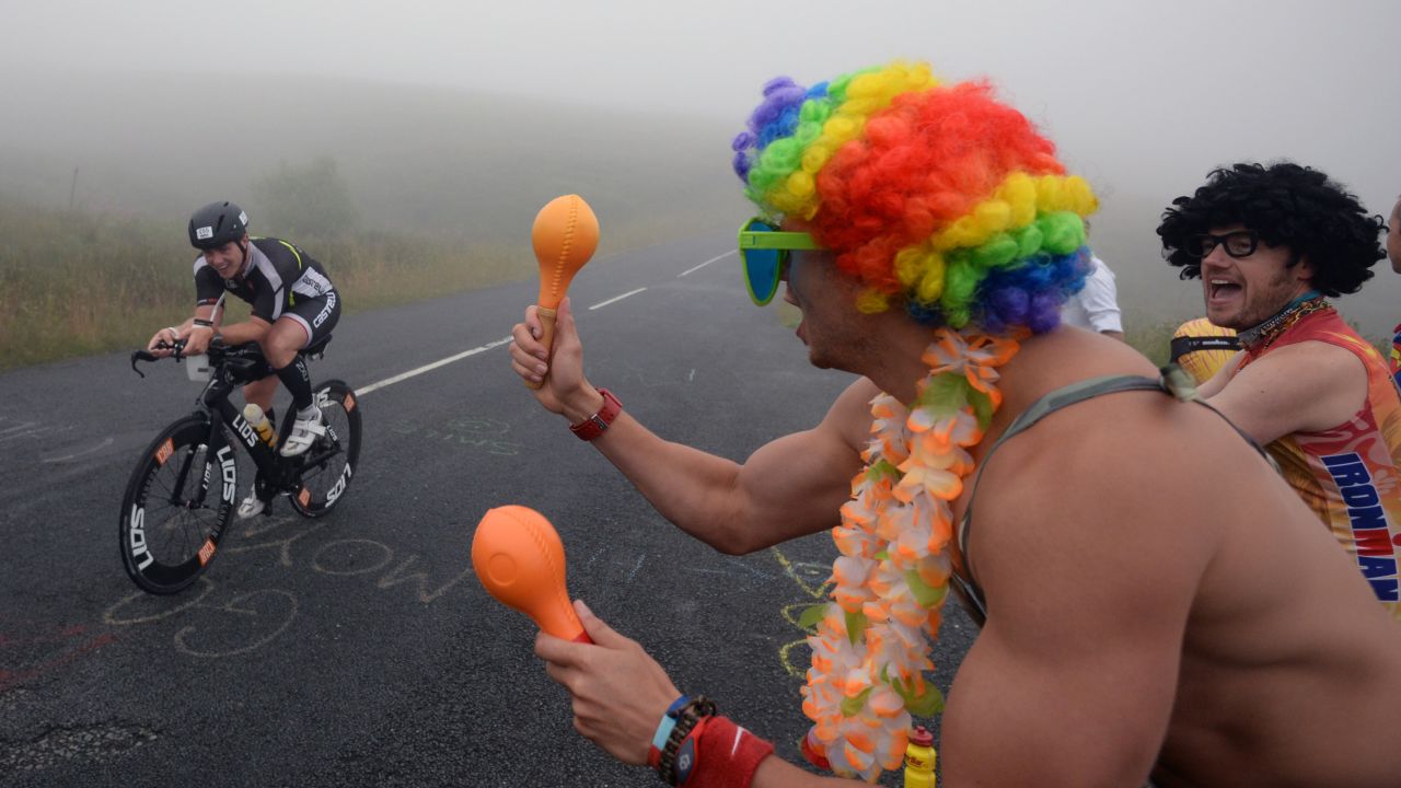 Spectators cheer on an athlete competing in the Ironman triathlon Sunday, July 20, in Bolton, England.