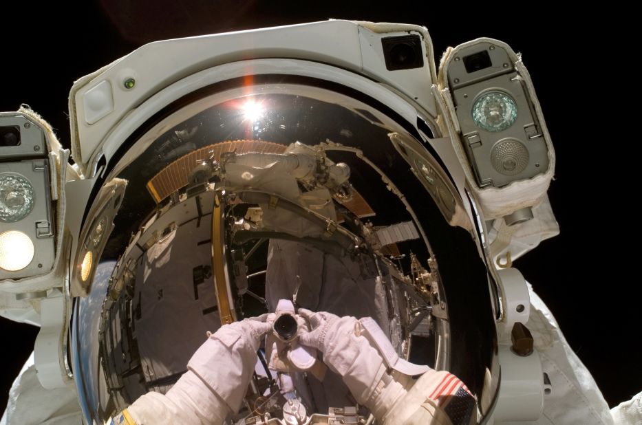 Astronaut Heidemarie M. Stefanyshyn-Piper, STS-115 mission specialist, takes a self-portrait during a spacewalk on September 12, 2006 that marked the continuation of construction on the ISS.