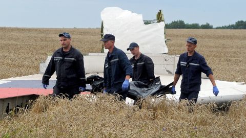 A body is removed from the site of the downed MH17 aircraft in eastern Ukraine.