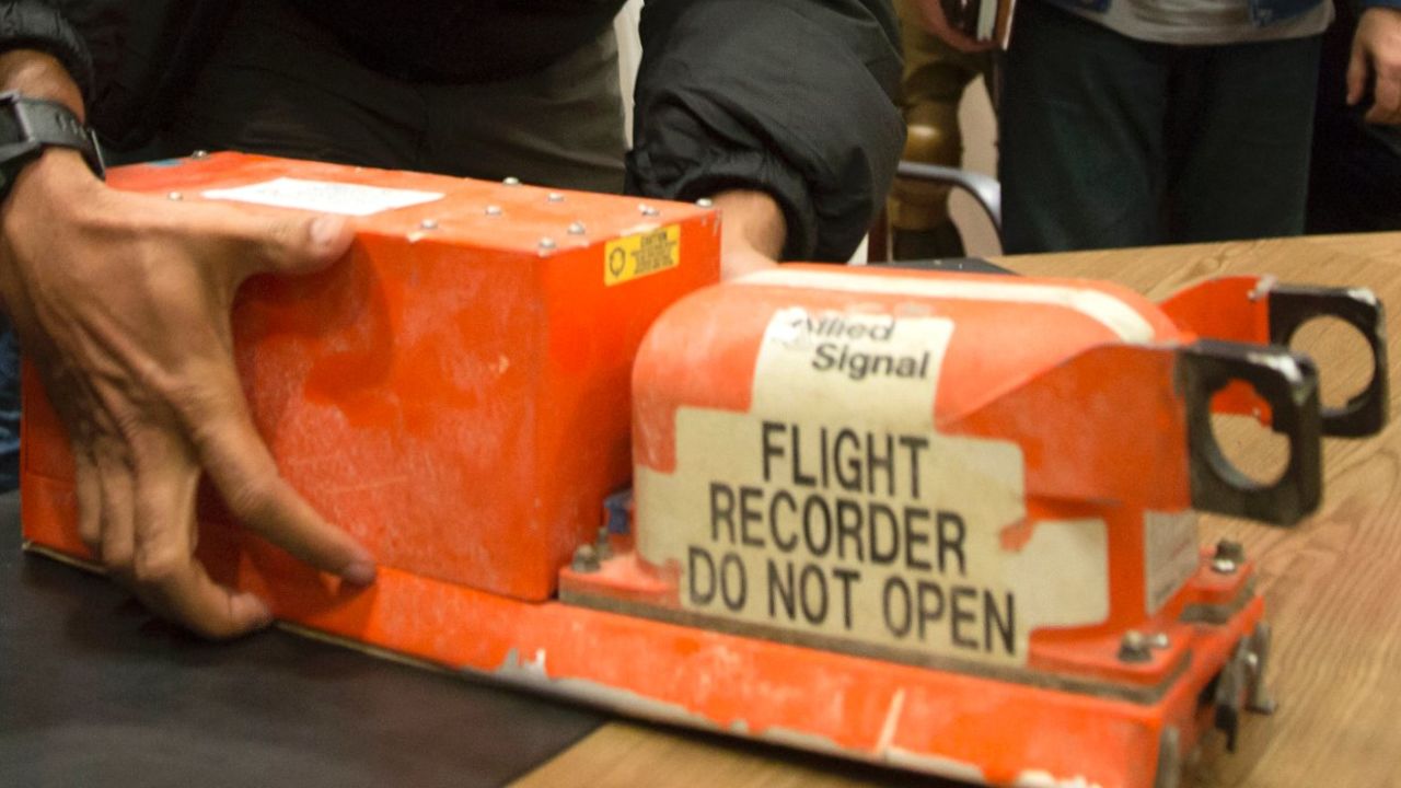 A Malaysian investigator takes a black box from Malaysia Airlines Flight 17 as it is handed over from Donetsk People's Republic officials to Malaysian representatives in the city of Donetsk, eastern Ukraine Tuesday, July 22, 2014. Bowing to international pressure Monday, pro-Moscow separatists released a train packed with bodies and handed over the black boxes from the downed Malaysia Airlines plane, four days after it plunged into rebel-held eastern Ukraine.