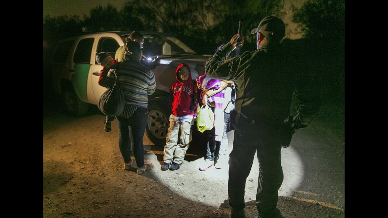 In this photo taken Thursday, July 3, Honduran mothers and their children prepare to get into a U.S. Customs and Border Protection truck after crossing the Rio Grande near McAllen, Texas. About 90 Hondurans a day cross there illegally, according to the Honduran Consulate.