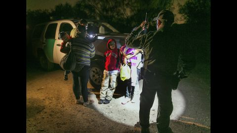 In this photo taken Thursday, July 3, Honduran mothers and their children prepare to get into a U.S. Customs and Border Protection truck after crossing the Rio Grande near McAllen, Texas. About 90 Hondurans a day cross there illegally, according to the Honduran Consulate.