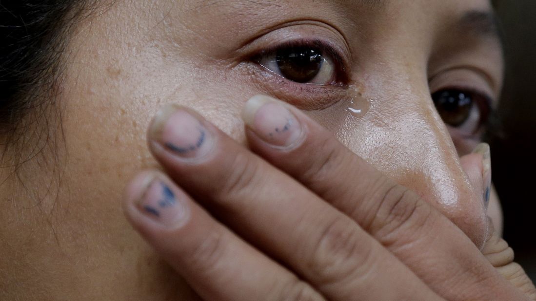 Cindy Jimenez, of Olancho, Honduras, wipes away tears at the bus station after she was released from a U.S. Customs and Border Protection processing facility in McAllen on Friday, June 20. Jimenez crossed illegally at zone nine, one of the busiest corridors on the U.S.-Mexico border for illegal crossings.