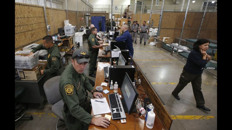 Officers in Nogales wait for new arrivals in the area where hundreds of mostly Central American immigrant children were being processed and held on Wednesday, June 18.