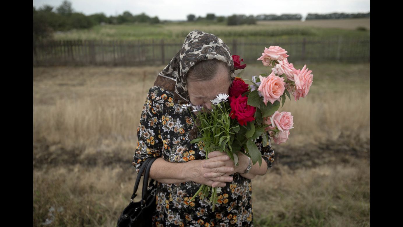 A woman cries July 22 during a service near the crash site.