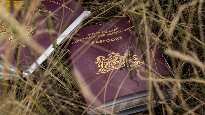 Two Dutch passports lie in the field on July 22.