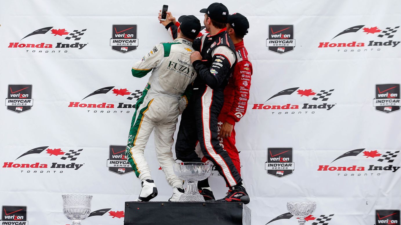 From left, IndyCar drivers Mike Conway, Will Power and Tony Kanaan pose for a photo together after a race in Toronto on Sunday, July 20. Conway finished first, ahead of Kanaan and then Power. 