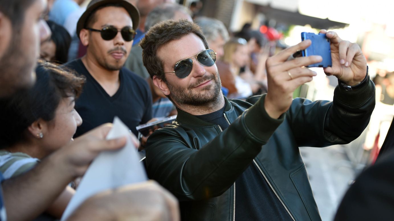 Actor Bradley Cooper snaps a selfie with fans Monday, July 21, at the premiere of "Guardians of the Galaxy" in Hollywood.