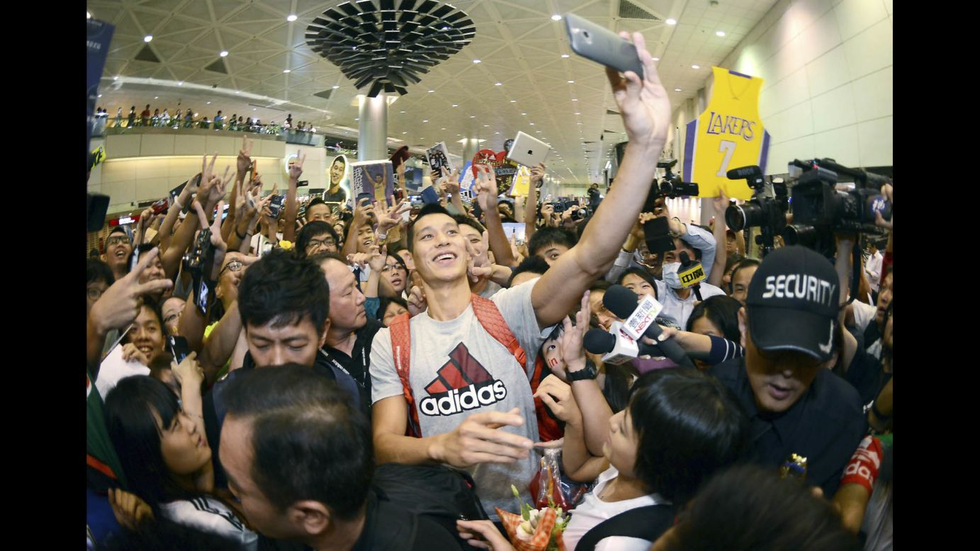 Pro basketball player Jeremy Lin takes a selfie with fans as he arrives at the Taiwan Taoyuan International Airport on Thursday, July 17. Lin, who was recently traded to the Los Angeles Lakers, traveled to Taiwan to host basketball clinics and attend charity events.