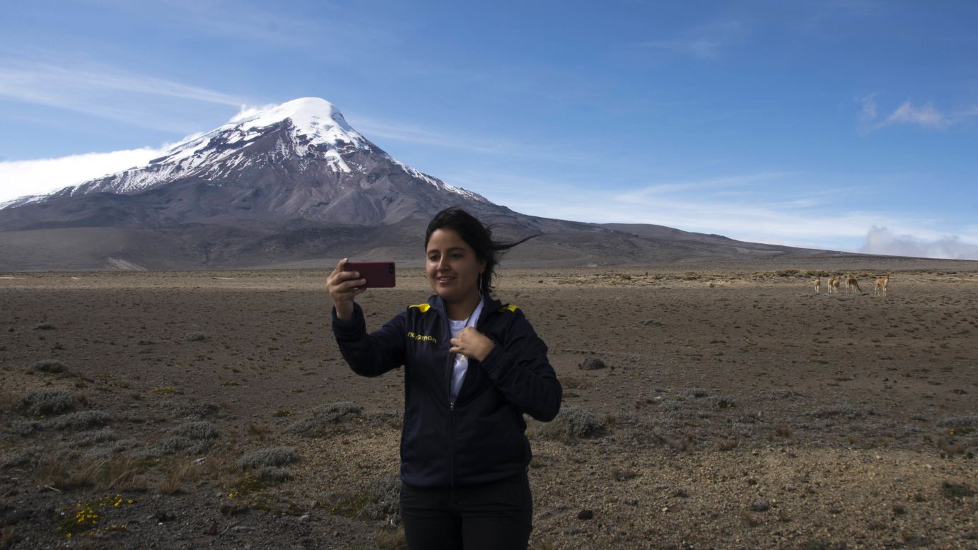 A woman takes a selfie with Ecuador's Mount Chimborazo on Friday, July 18. Chimborazo is the highest mountain in Ecuador, with a peak elevation of 20,564 feet.