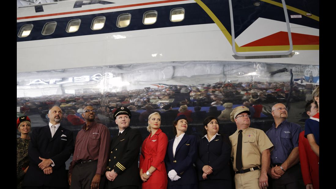 Airline employees -- some wearing vintage uniforms -- pose in front of a 1980s-era Boeing 767 dubbed "The Spirit of Delta" at the museum's June grand opening. 