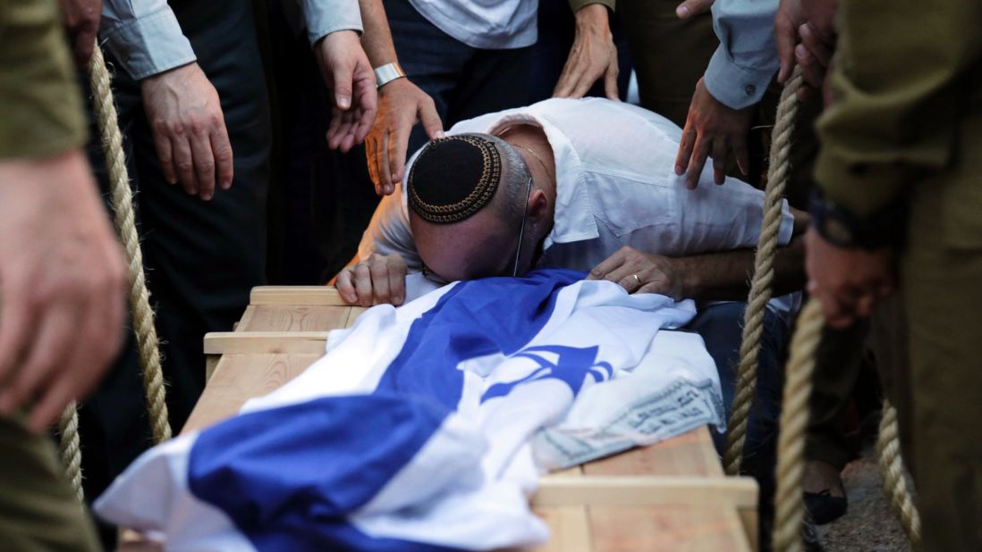 A relative of Israeli soldier Jordan Ben-Simon mourns over his coffin during his funeral in Ashkelon, Israel, on July 22.