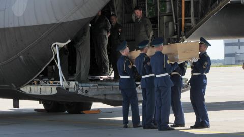 A Ukrainian honor guard loads a coffin onto a cargo plane at Kharkiv's airport on July 23.