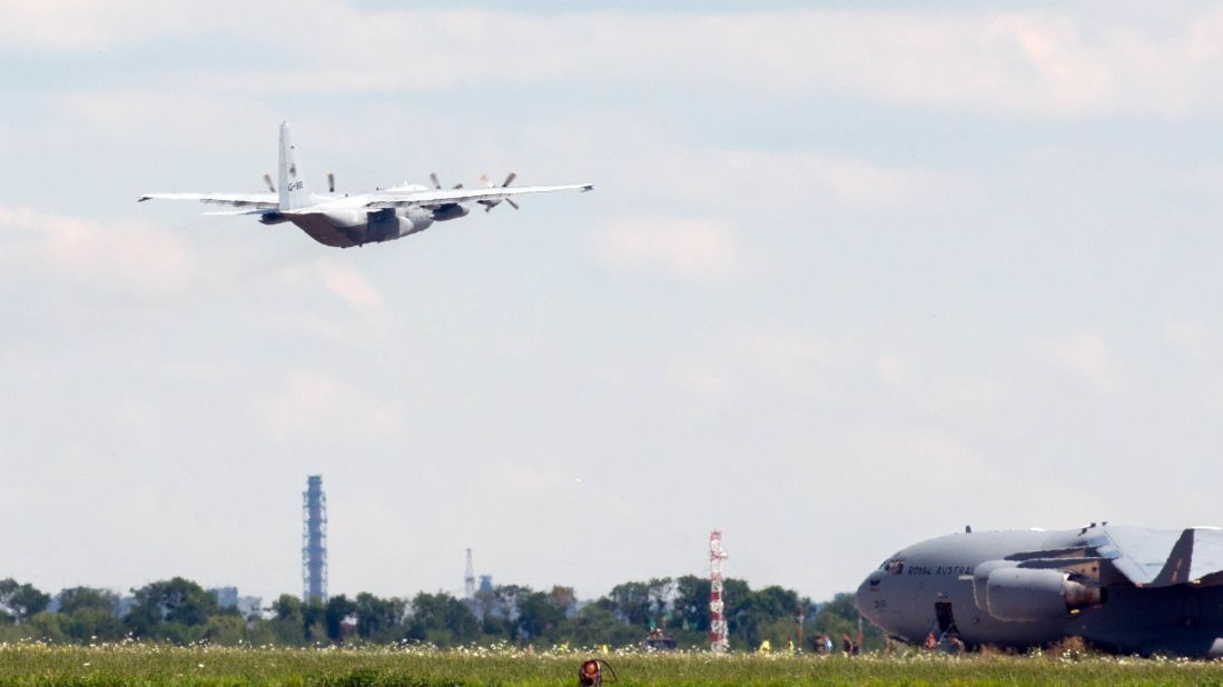A transport airplane with the Royal Netherlands Air Force, carrying the bodies of some Flight 17 victims, takes off from Kharkiv on July 23.