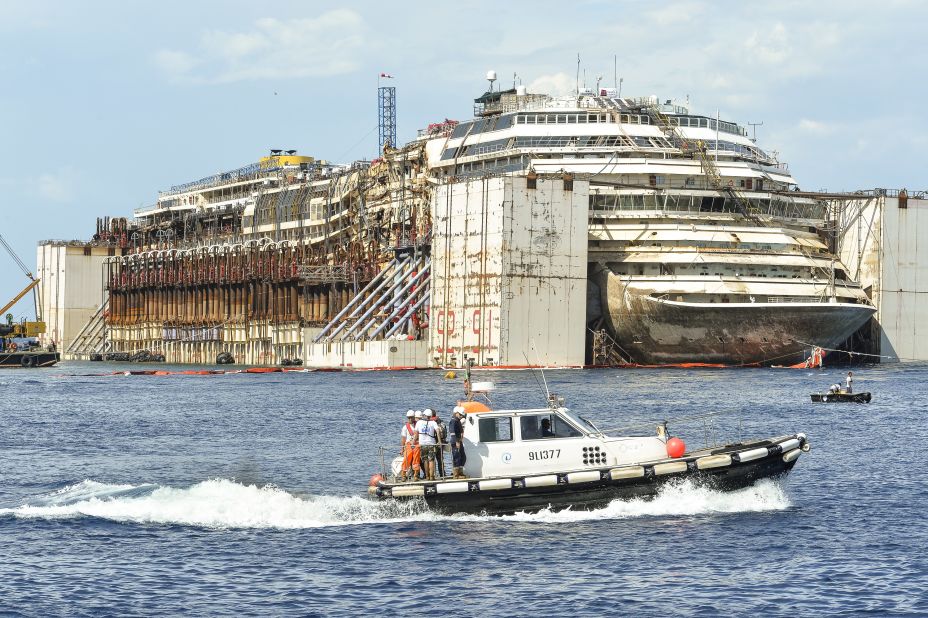 The Costa Concordia cruise ship sits in front of the harbor of Giglio Island after it was refloated using air tanks attached to its sides on Tuesday, July 22.  Environmental concerns prompted the decision to undertake the expensive and difficult process of refloating the ship rather than taking it apart on site.
