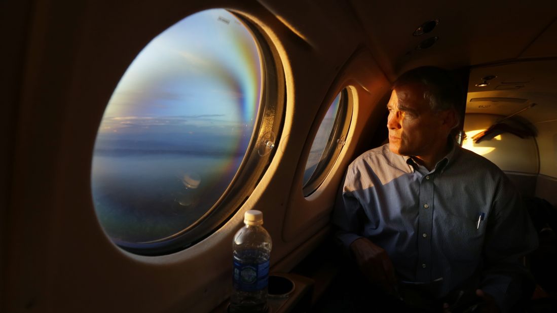 As the sun sets Friday, July 18, Washington Gov. Jay Inslee looks out his airplane window and sees smoke from the Chiwaukum Creek Fire near Leavenworth, Washington. Inslee was returning from a tour of areas affected by the wildfires.