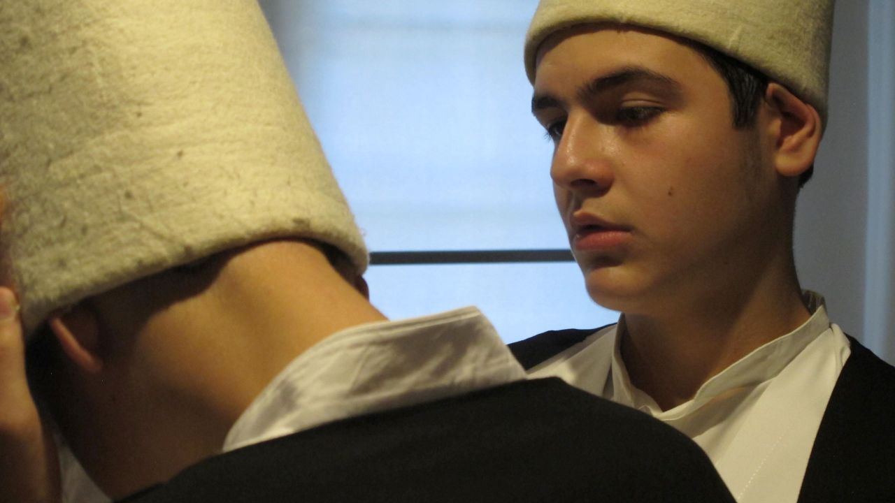 When CNN visits, two teenage Dervishes are conducting their debut sema ritual in public. The young semazens, aged 14 and 15, wear white felt hats rather than the traditional brown.