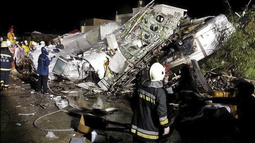 Rescue workers survey the wreckage of TransAsia Airways flight GE222 which crashed while attempting to land in stormy weather on the Taiwanese island of Penghu, on July 23.