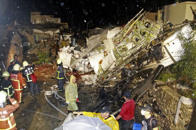 Rescuers work at the crash site on Wednesday, July 23. Flight GE222 was a twin-engine turboprop plane. 