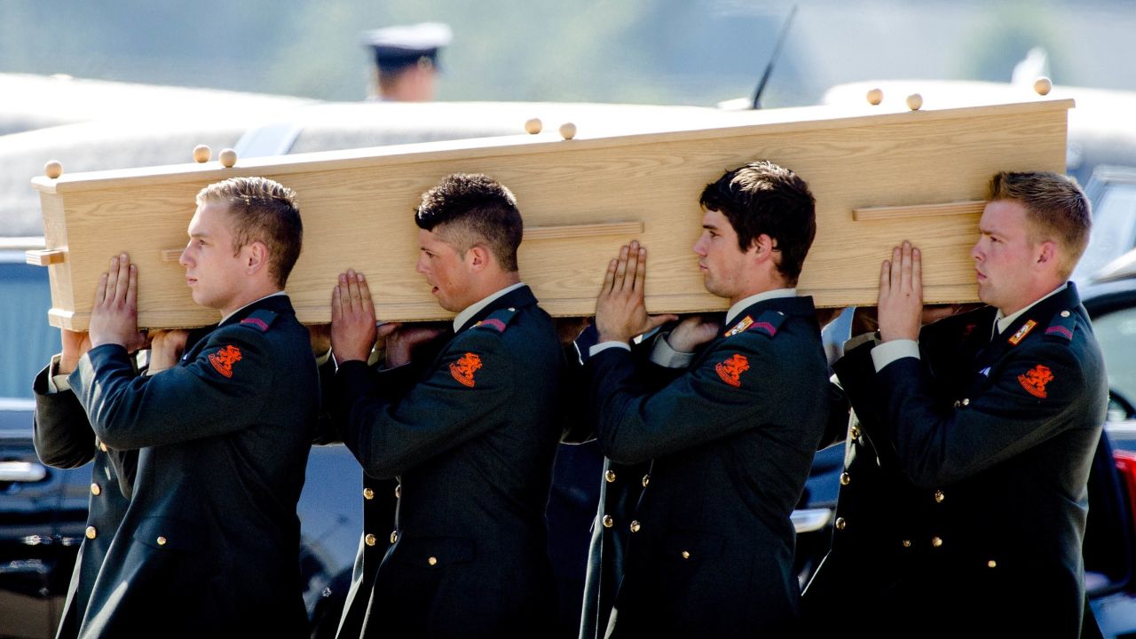 Dutch military personnel carry a coffin to a hearse in Eindhoven on July 23.