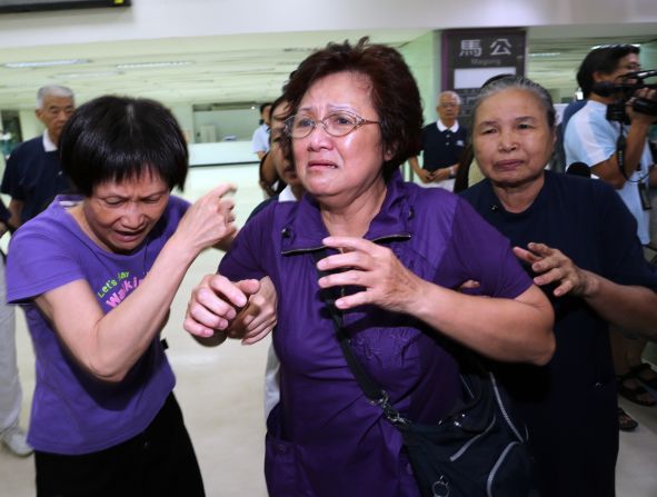 Relatives of passengers are seen at Kaohsiung International Airport in Kaohsiung, Taiwan, on July 23. Before Flight GE222 took off from Kaohsiung, it had been delayed due to conditions related to a typhoon, the airline said.