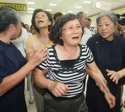 A passenger's relative reacts at the airport in Kaohsiung on July 23.