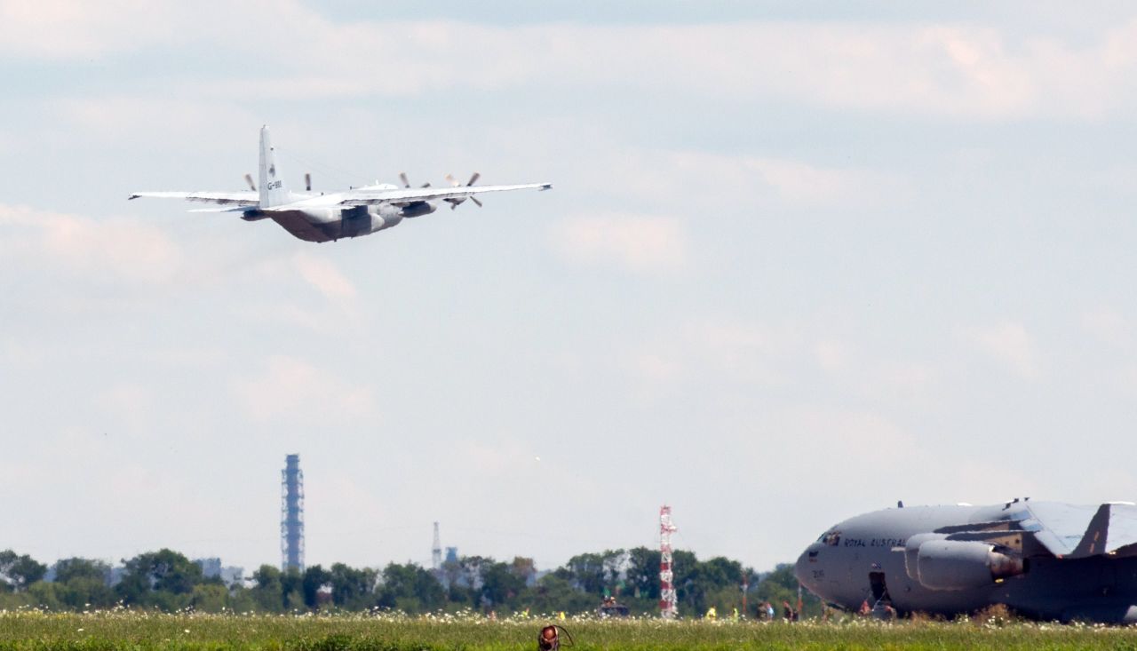 The Hercules carrying the bodies takes off from Kharkiv airport, as a C17 aircraft from the Royal Australian Air Force taxis.